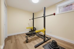 Wood-finish flooring, white trim, and a high-set window - 