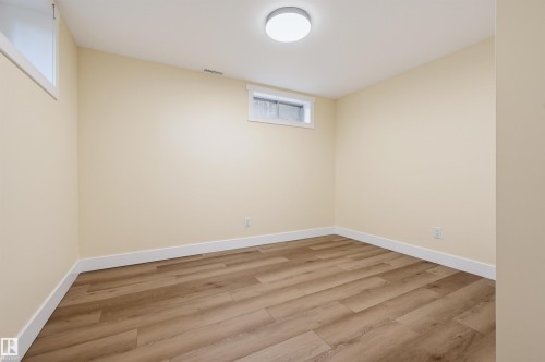 Wood-finish flooring, neutral wall tones, white trim, and a flush-mount ceiling light - 30 Gariepy Crescent Nw, Edmonton, AB 