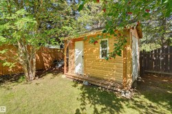 Wood-sided shed with a single window and small porch - 