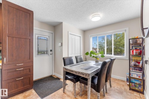 Built-in wood-finish cabinetry, bright window with blinds, and durable tile flooring - 16012 98 Avenue Nw, Edmonton, AB 