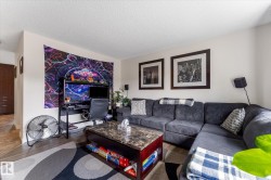 Recessed lighting, wood-finish flooring, and white painted walls - 