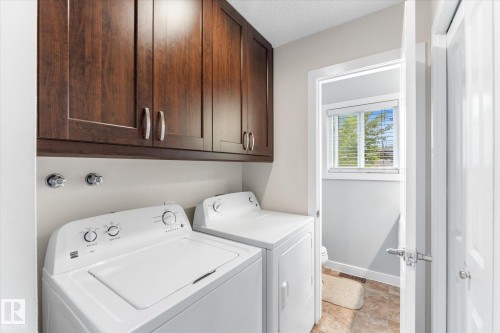 Built-in wood-finish cabinetry, light-toned walls, and a window with blinds - 16012 98 Avenue Nw, Edmonton, AB 