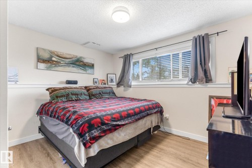 Recessed lighting, wood-finish flooring, and a large window with blinds - 16012 98 Avenue Nw, Edmonton, AB 