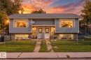 Duplex exterior featuring light gray siding, a dark gray roof, and prominent front windows - 16012 98 Avenue Nw, Edmonton, AB 
