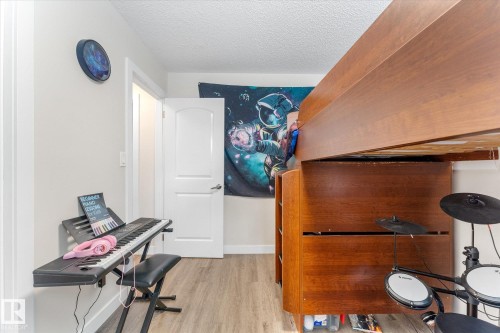 Wood-finish flooring with light-toned walls and white trim - 16012 98 Avenue Nw, Edmonton, AB 