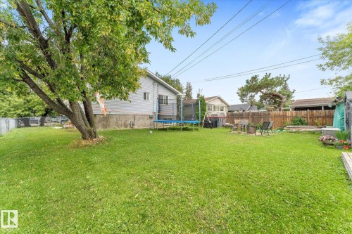Expansive backyard featuring a mature tree, a manicured lawn, and perimeter fencing - 16012 98 Avenue Nw, Edmonton, AB 