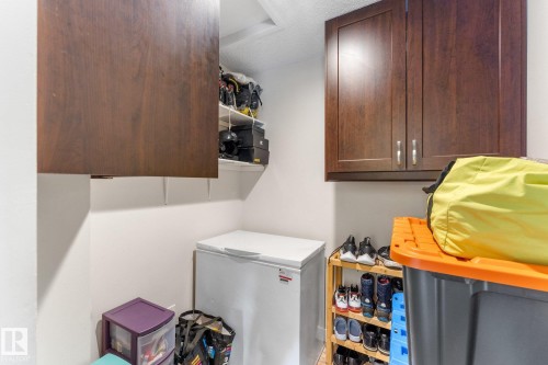 Built-in cabinetry with wood-finish doors and metal pulls, complemented by open shelving for additional storage - 16012 98 Avenue Nw, Edmonton, AB 