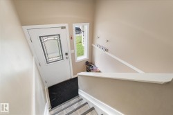 Entry door with decorative glass insert and adjacent window - 