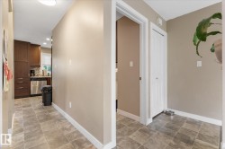 Kitchen with wood-finish cabinetry, stainless steel appliances, and tile flooring - 