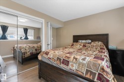 Mirrored sliding closet doors, wood-finish flooring, and neutral wall paint - 