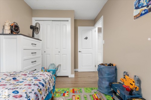 Wood-finish flooring with a neutral wall palette - 16012 98 Avenue Nw, Edmonton, AB 