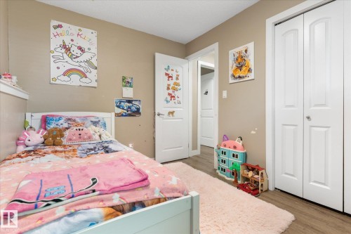 Neutral-toned walls complement wood-finish flooring - 16012 98 Avenue Nw, Edmonton, AB 