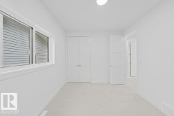 Carpeted room featuring a white interior, white trim, and a horizontal sliding window - 