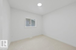 Neutral-toned carpeting complements the white walls and trim - 