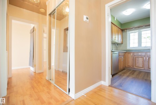 Wood-finish flooring throughout, mirrored closet doors, and recessed lighting - 13032 120 Street Nw, Edmonton, AB 