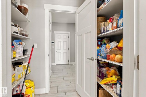 Walk-in pantry with ample shelving and a privacy door - 2011 Genesis Lane, Stony Plain, AB 