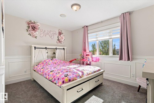Wall paneling, carpeted flooring, large window with blinds, ceiling-mounted light fixture, recessed ceiling lighting - 2011 Genesis Lane, Stony Plain, AB 