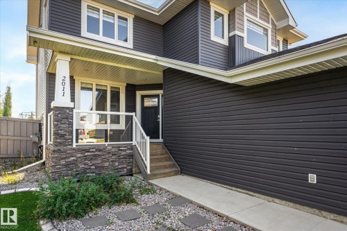 Dark horizontal siding and stone veneer exterior - 2011 Genesis Lane, Stony Plain, AB 