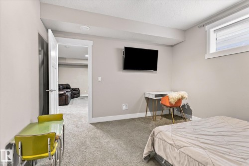 Recessed ceiling lighting, window with horizontal blinds, wall-mounted television bracket, and light gray wall paint - 2011 Genesis Lane, Stony Plain, AB 