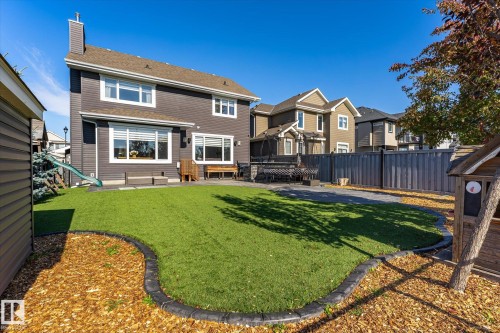 Manicured green lawn with decorative border, spacious patio, and privacy fencing - 2011 Genesis Lane, Stony Plain, AB 