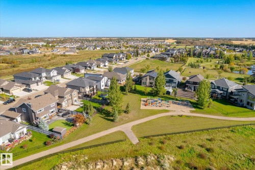 Neighborhood featuring a community park with playground equipment and paved walking paths - 2011 Genesis Lane, Stony Plain, AB 