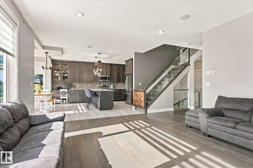 Open-concept living space with wood-finish flooring - 2011 Genesis Lane, Stony Plain, AB 