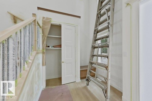 Staircase featuring wood handrails and balusters - 9216 91 Street Nw, Edmonton, AB - Indoor