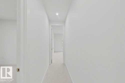 Central hallway with recessed lighting and light-toned wall-to-wall carpeting - 9216 91 Street Nw, Edmonton, AB - Indoor Photo Showing Other Room