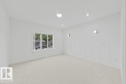 Spacious room with plush light-colored carpet and recessed ceiling lighting - 9216 91 Street Nw, Edmonton, AB - Indoor
