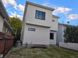 Modern exterior design featuring light-colored horizontal siding, dark-framed windows, and a sloped roofline - 