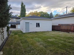 Detached garage with horizontal siding, a side entry door, and a single window - 