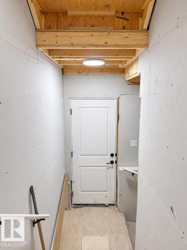 Interior space featuring exposed wood ceiling joists and subflooring, drywall-finished walls, and a recessed ceiling light fixture - 9216 91 Street Nw, Edmonton, AB - Indoor