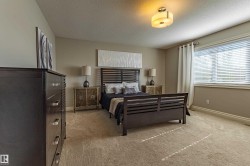 Recessed window with blinds and drapes, wall-to-wall carpeting, and a flush mount ceiling light fixture - 