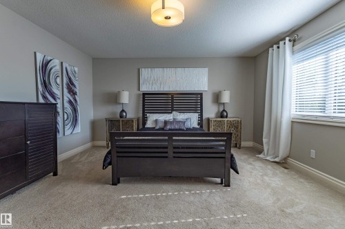 Neutral-toned walls, recessed lighting, and a window with blinds provide natural light - 233 Hawks Ridge Boulevard Nw, Edmonton, AB 