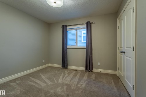 Neutral paint finishes, plush carpet flooring, and white trim work - 233 Hawks Ridge Boulevard Nw, Edmonton, AB 