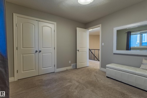 Light gray wall paint, recessed lighting, white trim, and carpeted flooring - 233 Hawks Ridge Boulevard Nw, Edmonton, AB 