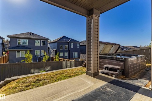 Concrete patio featuring an integrated spa - 233 Hawks Ridge Boulevard Nw, Edmonton, AB 