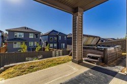 Concrete patio featuring an integrated spa - 