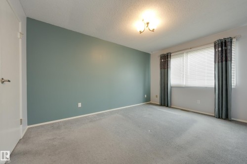 Wall-to-wall carpeting, window with blinds, and ceiling-mounted light fixture - 3421 135A Avenue Nw, Edmonton, AB 