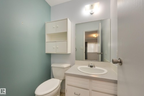 White vanity with an integrated sink and laminate countertop - 3421 135A Avenue Nw, Edmonton, AB 