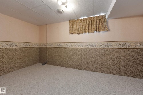 Wall-to-wall carpeting with a drop ceiling and recessed lighting - 3421 135A Avenue Nw, Edmonton, AB 