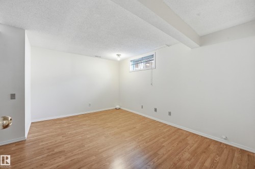 Wood-finish flooring with white walls and trim - 11102 11A Avenue Nw, Edmonton, AB 