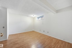 Wood-finish flooring with white walls and trim - 