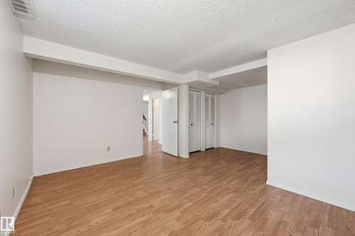 Wood-finish flooring with white walls - 11102 11A Avenue Nw, Edmonton, AB 