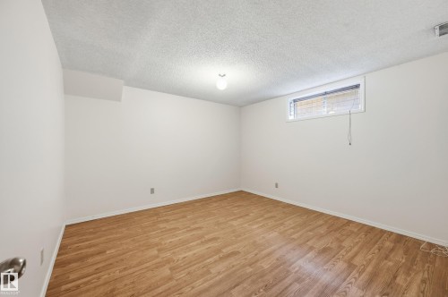 Wood-finish flooring, white walls, and a window with blinds - 11102 11A Avenue Nw, Edmonton, AB 