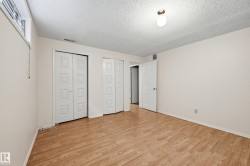 Wood-finish flooring throughout, two bi-fold panel doors, and a single pane window - 