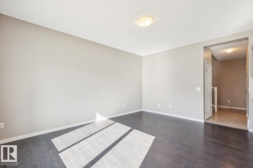 Dark wood-finish flooring complements light-toned walls - 12007 173 Avenue Nw, Edmonton, AB 