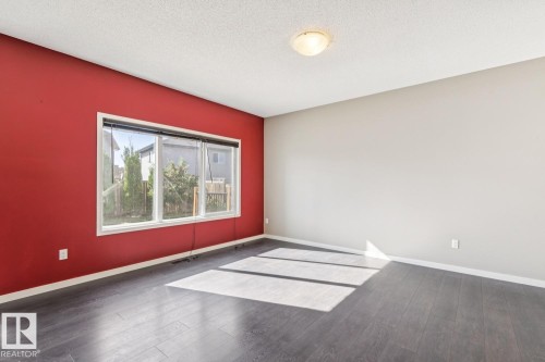 Wood-finish flooring, white trim, and a flush mount ceiling light - 12007 173 Avenue Nw, Edmonton, AB 