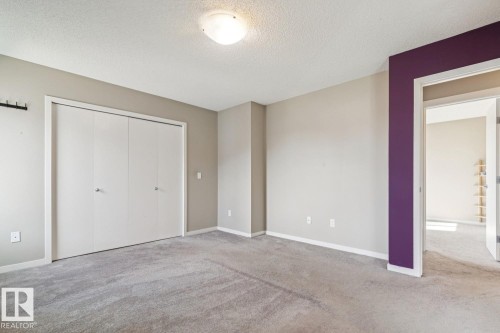 Broadloom carpeting, overhead flush mount lighting, and a closet with bifold doors - 12007 173 Avenue Nw, Edmonton, AB 