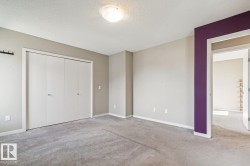 Broadloom carpeting, overhead flush mount lighting, and a closet with bifold doors - 